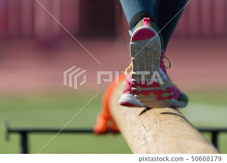 The feet of a athlete as she's walking on a wooden The feet of a athlete as she's walking on a wooden 50608179