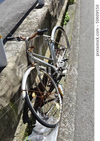 Untreated bicycle illegal dumping social problem 50609550