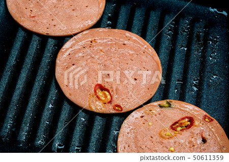Spices Bologna fried in pan Spices Bologna fried in pan 50611359