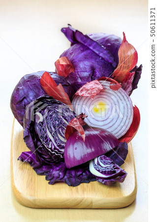 Red cabbage and onions on a cutting board Red cabbage and onions on a cutting board 50611371