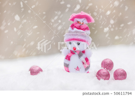 Snowman and christmas balls on snow Snowman and christmas balls on snow 50611794