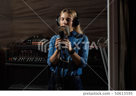 Young smiling blonde woman recording studio 50613595