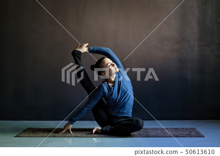 Sporty young caucasian woman doing asana Sporty young caucasian woman doing asana 50613610