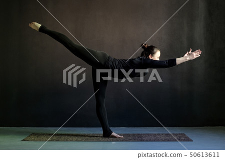 Slim young woman practicing yoga  50613611