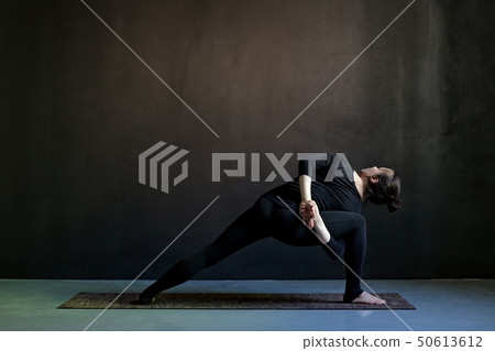 European woman doing Extended Side Angle posture 50613612