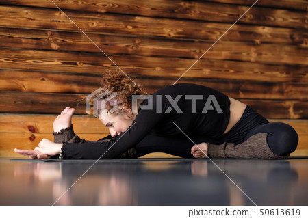 Young woman working out doing yoga or pilates Young woman working out doing yoga or pilates 50613619