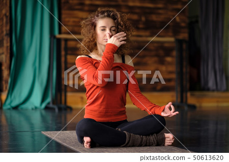 Young curly woman doing yoga exercises Young curly woman doing yoga exercises 50613620