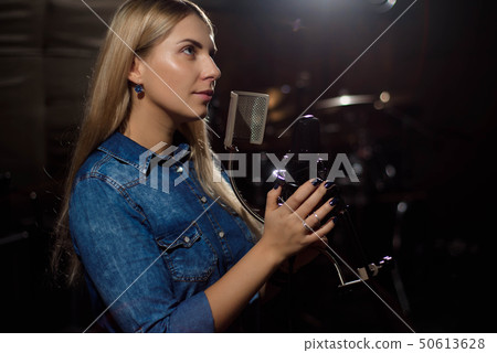 Close up of a singer recording a track in a studio 50613628