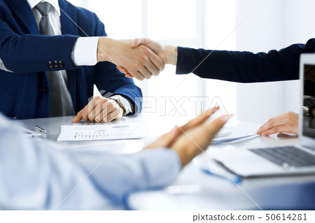 Business people shaking hands finishing up a meeting , close-up. Success at negotiation and 50614281