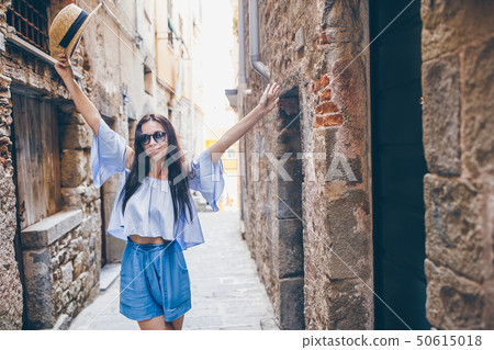 Happy young urban woman in european city. 50615018