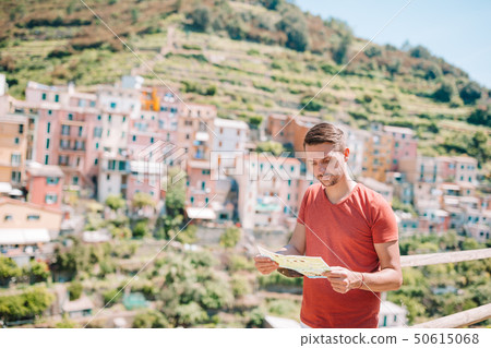 Young man tourist with map background stunning villag, Manarola, Cinque Terre, Liguria, Italy Young man tourist with map background stunning villag, Manarola, Cinque Terre, Liguria, Italy 50615068