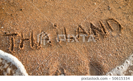 Closeup photo word Thailand written on wet sand. Concept of tourism, traveling, trips and journeys 50615334