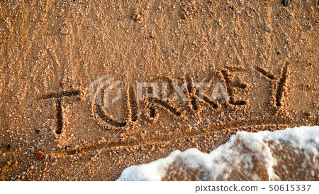 Closeup photo of word Turkey written on the sea beach. Concept of tourism, traveling, trips and 50615337