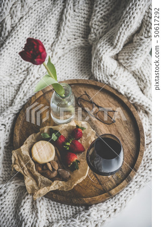 Glass of wine, different snacks and red tulip in 50617292