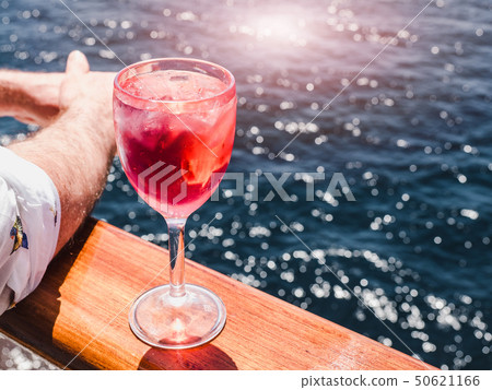 Wineglass with a pink cocktail and ice cubes Wineglass with a pink cocktail and ice cubes 50621166