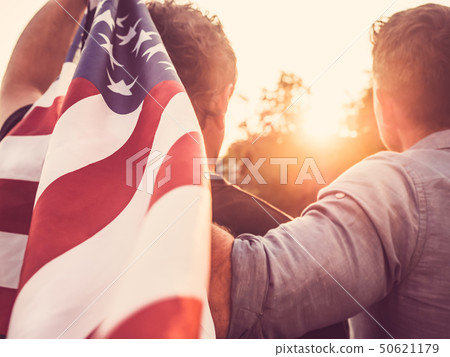Two friends hold American Flag at sunset Two friends hold American Flag at sunset 50621179