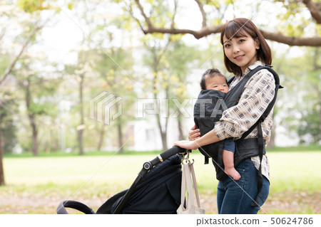 Mother pushing baby stroller baby strolling hug strap Mother pushing baby stroller baby strolling hug strap 50624786