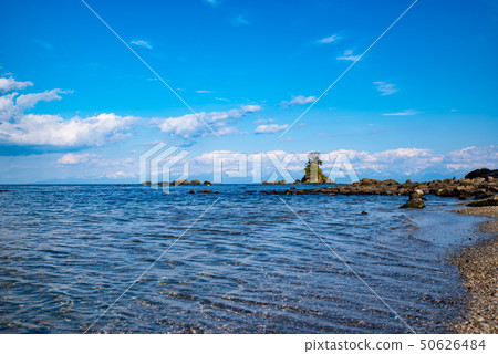 View of woman rock and Tateyama mountain range from Amaharu beach sandy beach 2010.04 b 50626484