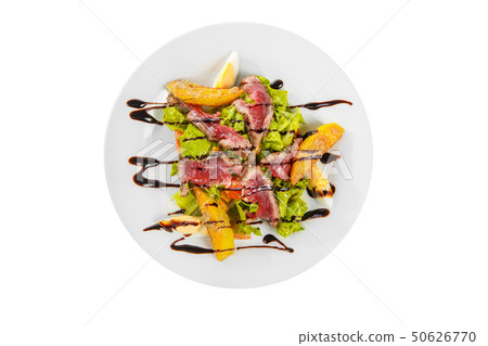Salad with roast beef on plate white isolated 50626770