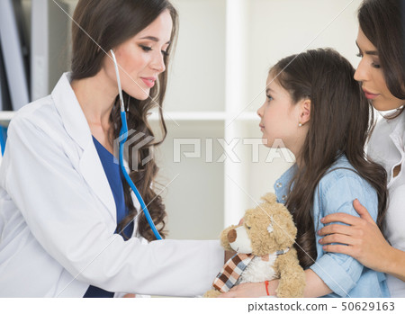 Pediatrician and little girl in 50629163