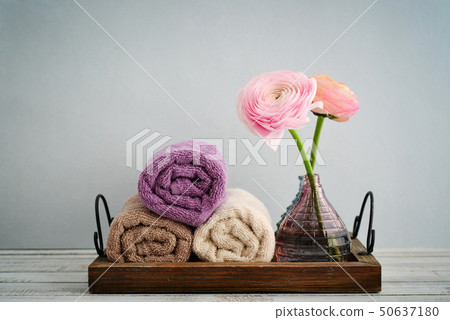 Folded towels with ranunculus Folded towels with ranunculus 50637180