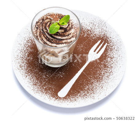 Classic tiramisu dessert in a glass on plate with fork silhouette isolated on a white with clipping 50638322