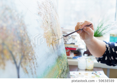 artist's hand draws oil painting close up 50638589