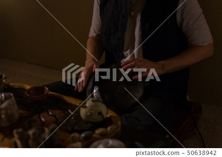 Man playing hang drum 50638942