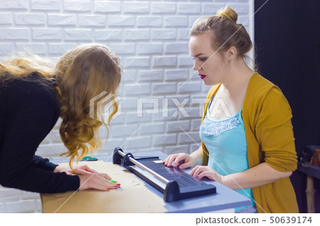 Professional women decorator working with kraft paper Professional women decorator working with kraft paper 50639174