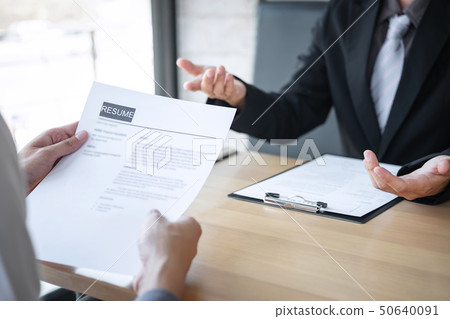 Employer or recruiter holding reading a resume 50640091