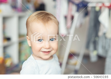 Cute adorable caucasian toodler boy laughing and having fun playing home with mess and clothes dryer 50643193
