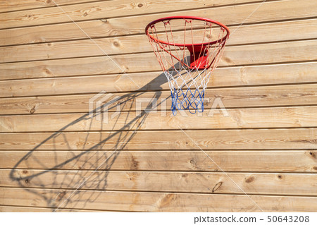 Basketball hoop hanged on wooden board background. Playground on backyard of home. Sport equipment Basketball hoop hanged on wooden board background. Playground on backyard of home. Sport equipment 50643208