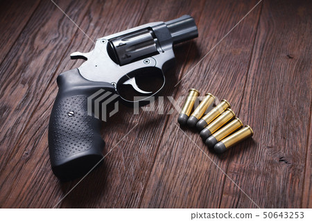 illegal handgun on wooden table illegal handgun on wooden table 50643253