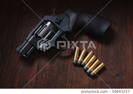 illegal handgun on wooden table illegal handgun on wooden table 50643257