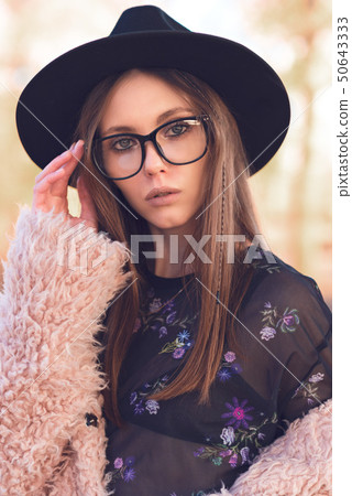 Beautiful girl in a fashionable pink lama coat. Beautiful girl in a fashionable pink lama coat. 50643333