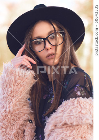 Beautiful girl in a fashionable pink lama coat. Beautiful girl in a fashionable pink lama coat. 50643335