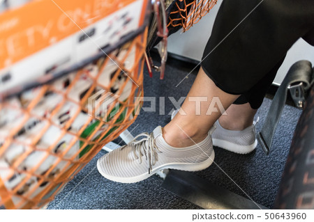 Female passenger with lack of leg space on long commercial airplane flight. Focus on casual sporty 50643960