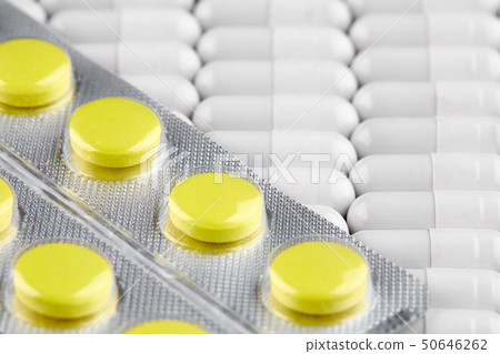 Blister with yellow pills on white capsules Blister with yellow pills on white capsules 50646262