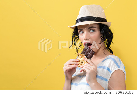 Young woman holding chocolate Young woman holding chocolate 50650193