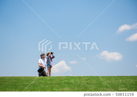 Father and daughter looking far away with binoculars Father and daughter looking far away with binoculars 50651159