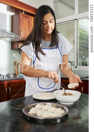 Woman cooking ravioli 50653315