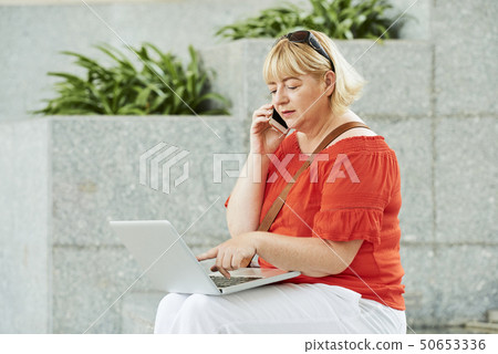 Businesswoman making phone call 50653336