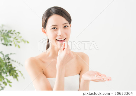 Portrait of a woman taking medicine Portrait of a woman taking medicine 50653364