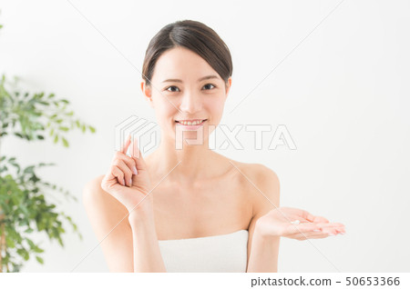 photo of woman with supplements 50653366