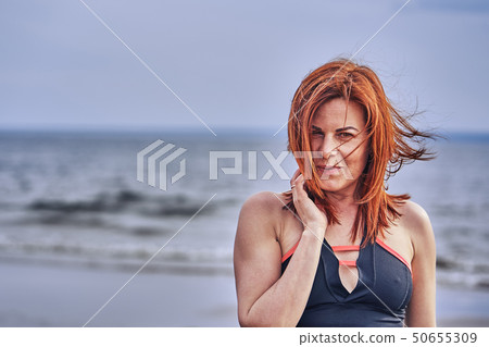 Portrait of a middle-aged woman with red hair 50655309