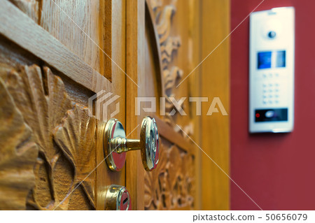 Wooden door with modern intercom Wooden door with modern intercom 50656079