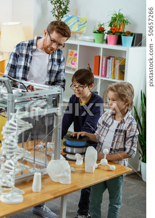 Curious little boys standing in laboratory and observing apparatus 50657266