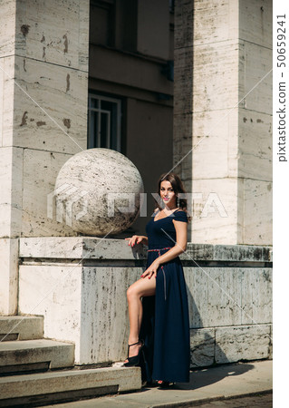 Gorgeous woman stand outside by the big stairs.Lady in Sexy evening dress 50659241