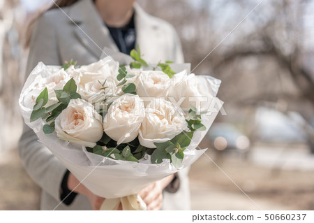 Mono bouquet of garden roses. Delicate bouquet of mixed flowers in womans hands. the work of the 50660237
