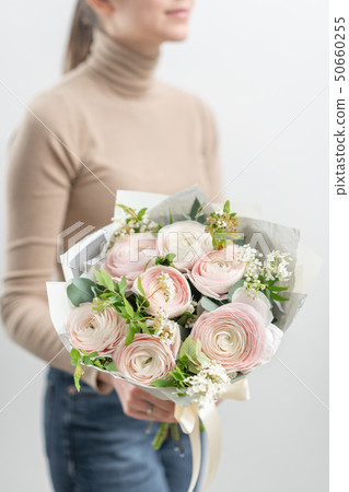 Mono bouquet of roses. Delicate bouquet of mixed flowers in womans hands. the work of the florist at Mono bouquet of roses. Delicate bouquet of mixed flowers in womans hands. the work of the florist at 50660255